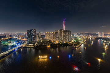 At night on the tallest building in Vietnam, there are boats running on the Saigon River. Photo...