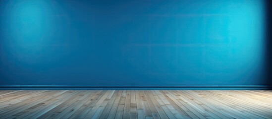 The empty room features a blue wall with tints and shades, contrasting against the hardwood floor. The electric blue hue creates a striking pattern in the rectangular space - obrazy, fototapety, plakaty
