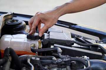 mechanic inspects the expansion tank with pink antifreeze. Vehicle coolant level in the car's...