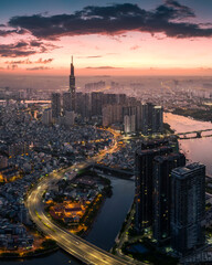 Sunrise on the tallest Landmark 81 building in Vietnam, with a beautiful curved road. Photo was...