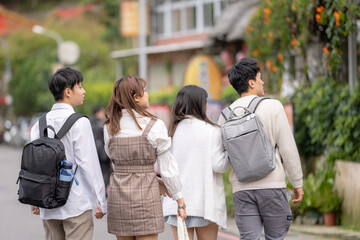 Four Taiwanese college students eat soft serve ice cream in the nature of Maokong, a tourist attraction in Wenshan District, Taipei City, Taiwan 台湾台北市文山区の観光名所の猫空の自然の中でソフトクリームを食べる台湾人の大学生の男女四人