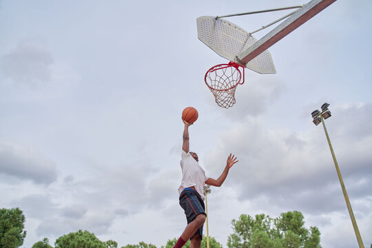 basketball player making slam dunk