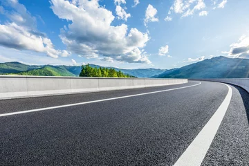 Rolgordijnen Asphalt highway road and green mountains with sky clouds background © ABCDstock