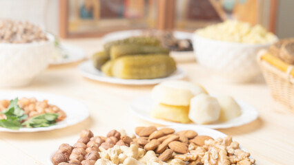Holy Week, End, Palm Sunday, Good Friday, Easter Sunday Concept. Orthodox food in Great Christian Lent, Lenten food on a wooden table against the background of Orthodox icons.