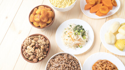 Holy Week, End, Palm Sunday, Good Friday, Easter Sunday Concept. Orthodox food in Great Christian Lent, Lenten food on a wooden table against the background of Orthodox icons.