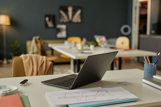 Background image of laptop computer at empty workplace desk with no people and clutter copy space