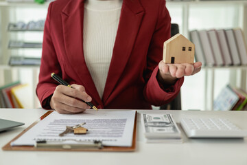 Asian female real estate agent employee recommends house to client Explain home interiors and...