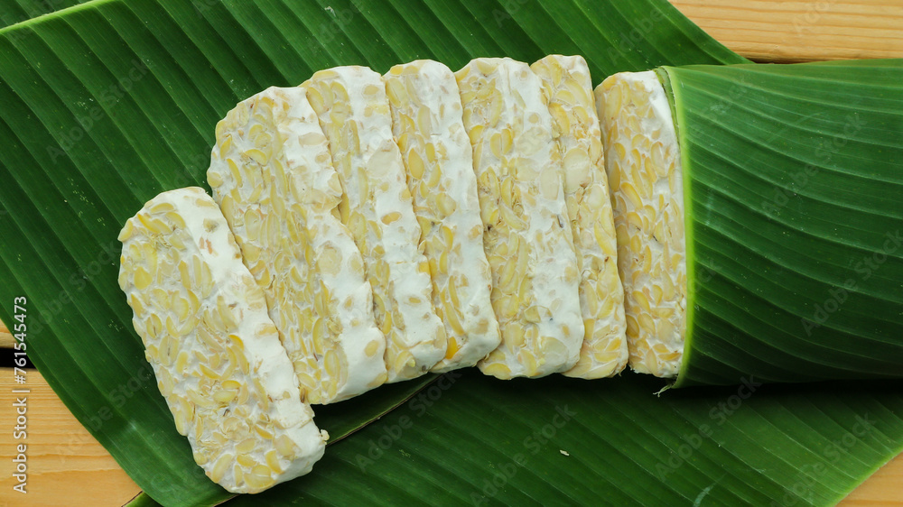 Wall mural Tempe slices on a banana leaves. Tempeh or Tempe is an Indonesian specialty.