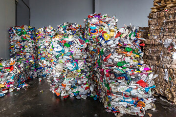 Fototapeta premium plastic pressed bales at the modern waste hazardous processing plant. Separate garbage collection. Recycling and storage of waste for further disposal. Business for sorting and processing of waste.