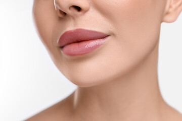 Obraz na płótnie Canvas Woman with beautiful lips on white background, closeup
