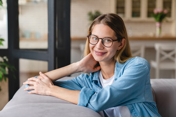 Young beautiful caucasian woman student tutor teacher businesswoman relaxing at home in glasses....