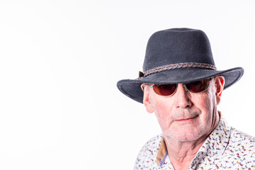 A portrait of a senior man exuding confidence and style, wearing a fedora hat and sunglasses...