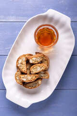 White tray with almond cantuccini and glass of sweet wine - 761568294