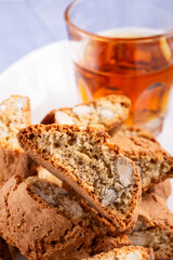 In the foreground the almond cantuccini and in the background a glass of sweet wine. - 761568490