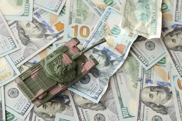 Tank on crumpled hundred dollar bills banknotes. Background of war funding and military support price for United States of America