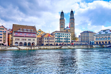 Limmat river and Grossmunster church, houses on the river's bank, Zurich, Switzerland
