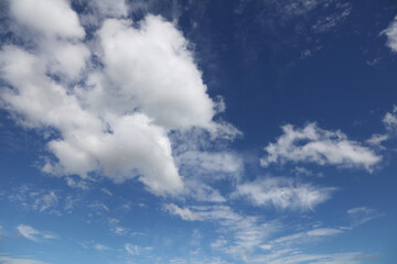 Fluffy white clouds in a blue sky  - 761581282
