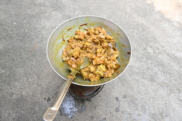 Cooking Goat meat in a Frying Pan on coal Stove at Home Kitchen. Sizzling chunks of juicy Goat meat...