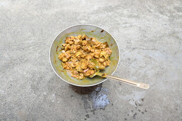 Cooking Goat meat in a Frying Pan on coal Stove at Home Kitchen. Sizzling chunks of juicy Goat meat fillet, with onions. Home delicious food. Make indian Goat meat curry in traditional style.