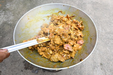 Cooking Goat meat in a Frying Pan on coal Stove at Home Kitchen. Sizzling chunks of juicy Goat meat fillet, with onions. Home delicious food. Make indian Goat meat curry in traditional style.