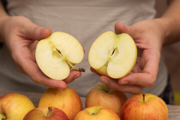 Hands Picking a Fresh Apple. Female hands holding fresh ripe apple.