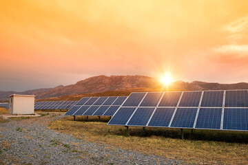 Sunset at Solar power station. Solar panels, photovoltaics, alternative source of electricity -...