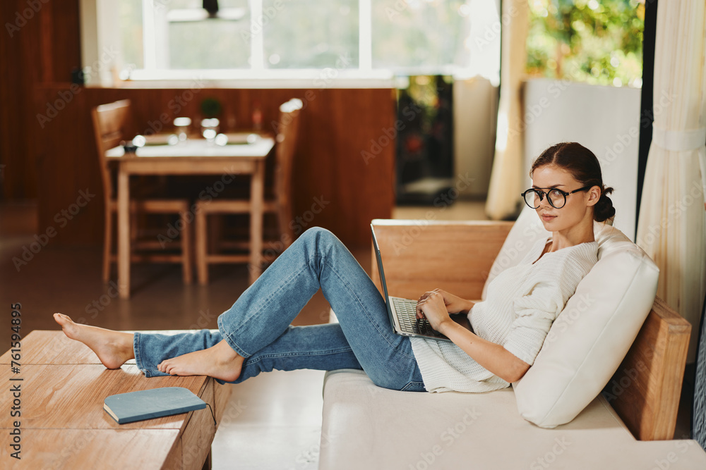 Canvas Prints Smiling Woman Working on Laptop in Cozy Home Office Freelancer Startup Lifestyle Description A beautiful woman with glasses sits comfortably on a couch in her modern home office With a bright smile on