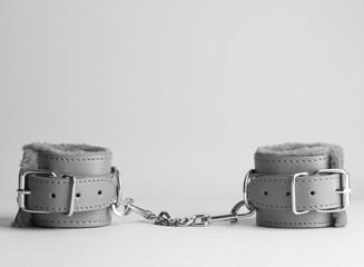 Handcuffs for sex over grey background