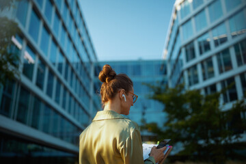 Seen from behind woman worker near office building
