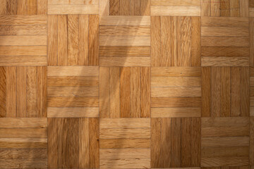 Wooden parquet or flooring inside room. Top view, natural light, no people
