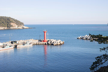 Red lighthouse in the middle of sea