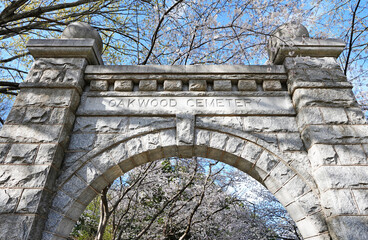 Historic Oakwood cemetery entrance and Spring trees in bloom in Raleigh North Carolina - 761606089