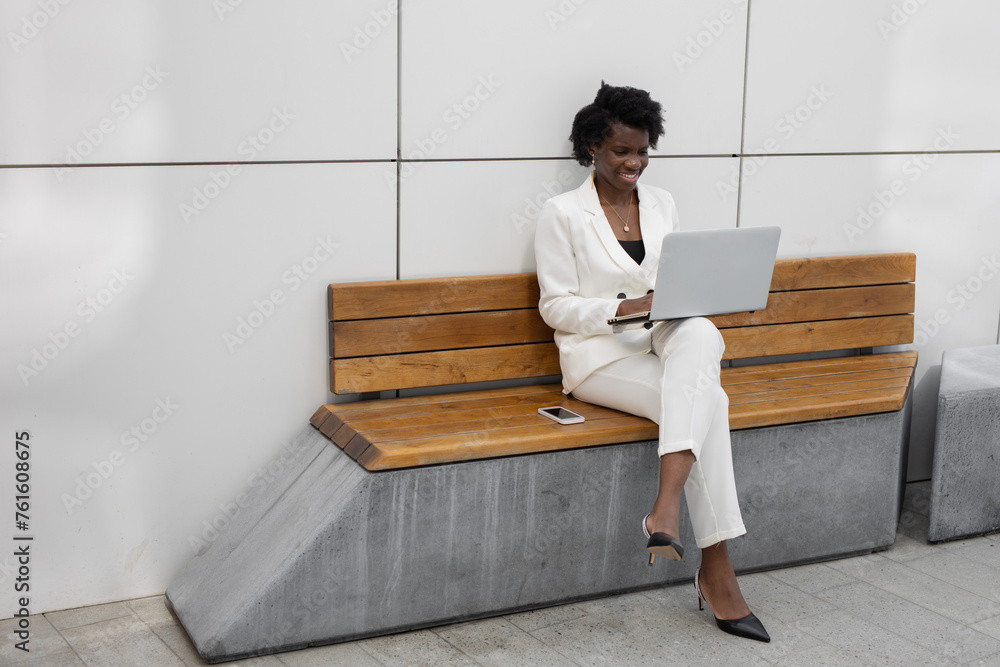 Sticker happy african businesswoman working with laptop