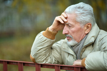 Portrait of thoughtful senior man in park