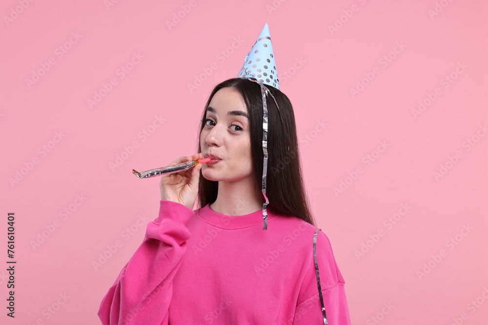 Canvas Prints Woman in party hat with blower and streamers on pink background