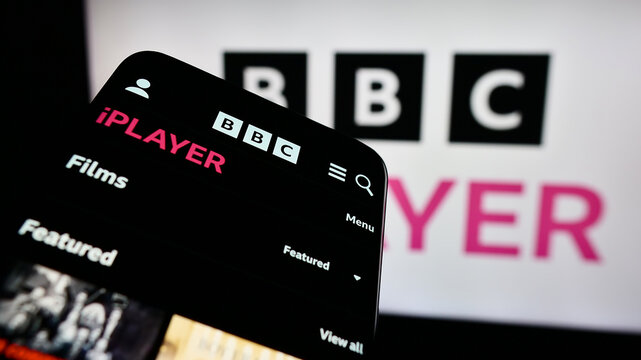 Stuttgart, Germany - 03-07-2024: Smartphone with website of British video on demand service BBC iPlayer in front of company logo. Focus on top-left of phone display.