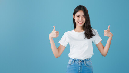 Portrait of a cheerful Asian girl giving a confident thumbs up gesture with a charming smile