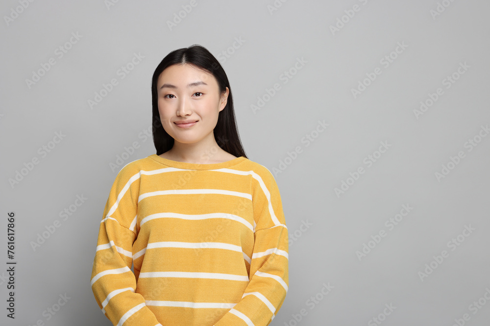 Poster Portrait of beautiful woman on grey background. Space for text