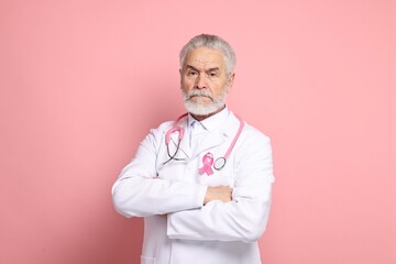 Mammologist with pink ribbon on color background. Breast cancer awareness