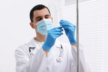 Doctor setting up IV drip in hospital