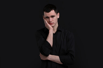 Obraz premium Portrait of sad man on black background