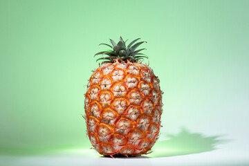 Azorean Pineapple on a green background. Fresh ripe tropical fruit. Pineapple (Ananas) fruit from Azores.