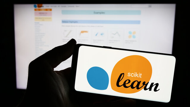 Stuttgart, Germany - 03-08-2024: Person holding smartphone with logo of software machine learning library scikit-learn in front of website. Focus on phone display.