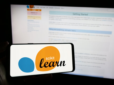 Stuttgart, Germany - 03-08-2024: Person holding cellphone with logo of software machine learning library scikit-learn in front of webpage. Focus on phone display.