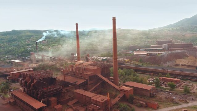 Aerial Establishing Shot of an Old Iron Factory with High Chimneys. Environmental Issue. Global warming. Climate crisis. Zenica, Bosnia and Herzegovina