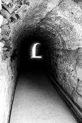 Stone tunnel with light at the end