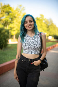 Portrait of a young beautiful slender girl with blue hair.