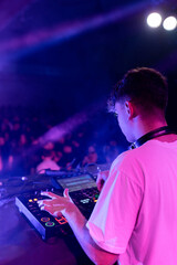 Fototapeta na wymiar A DJ mixing on stage using board