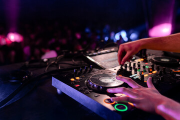 Close-up of the hands of a Dj mixing board