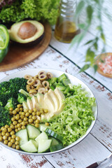 A bowl with a salad made of green vegetables
